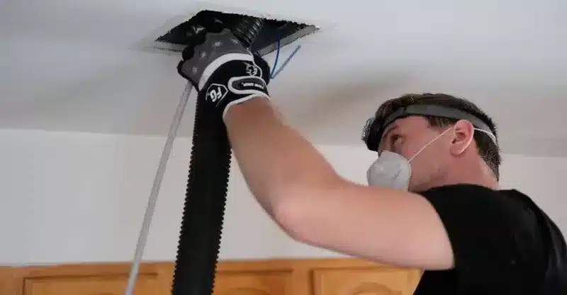 Technician reconnecting damaged flexible ducting