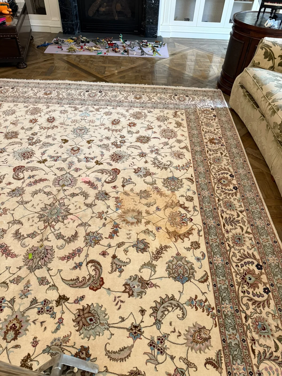 Before: ornate wool Persian rug with a large stain, cleaned on site